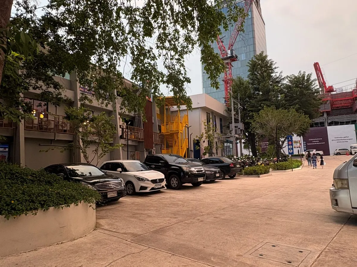 The lane inside Again Pattaya with parked cars and the yellow stairs ahead