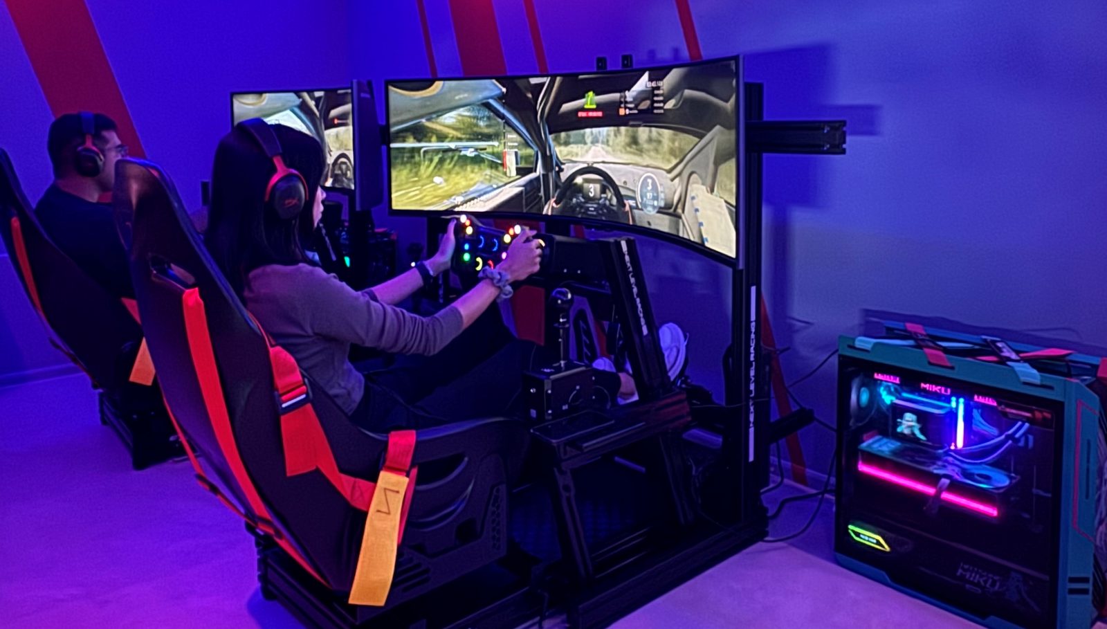 Two sim racing rigs in use in the neon-lit racing room at Level3 Hub Pattaya